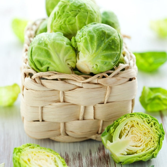 Fresh Brussels sprouts from SeedsNow, grown from Long Island Catskill seeds, shown on a wooden surface.