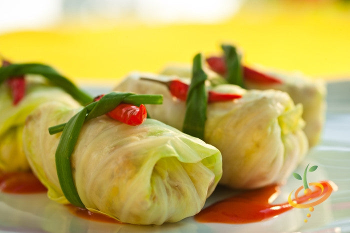 Charleston Wakefield cabbage rolls garnished with chili and herbs on a plate