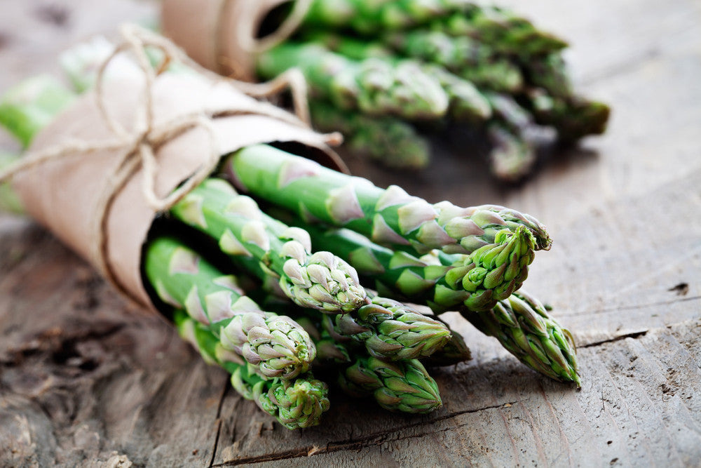 Mary Washington asparagus seeds from SeedsNow, showing fresh green asparagus spears ready for planting.