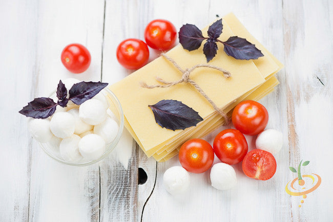 Red velvet leaf basil seeds from SeedsNow, showing fresh green basil leaves with vibrant red velvet-colored foliage.